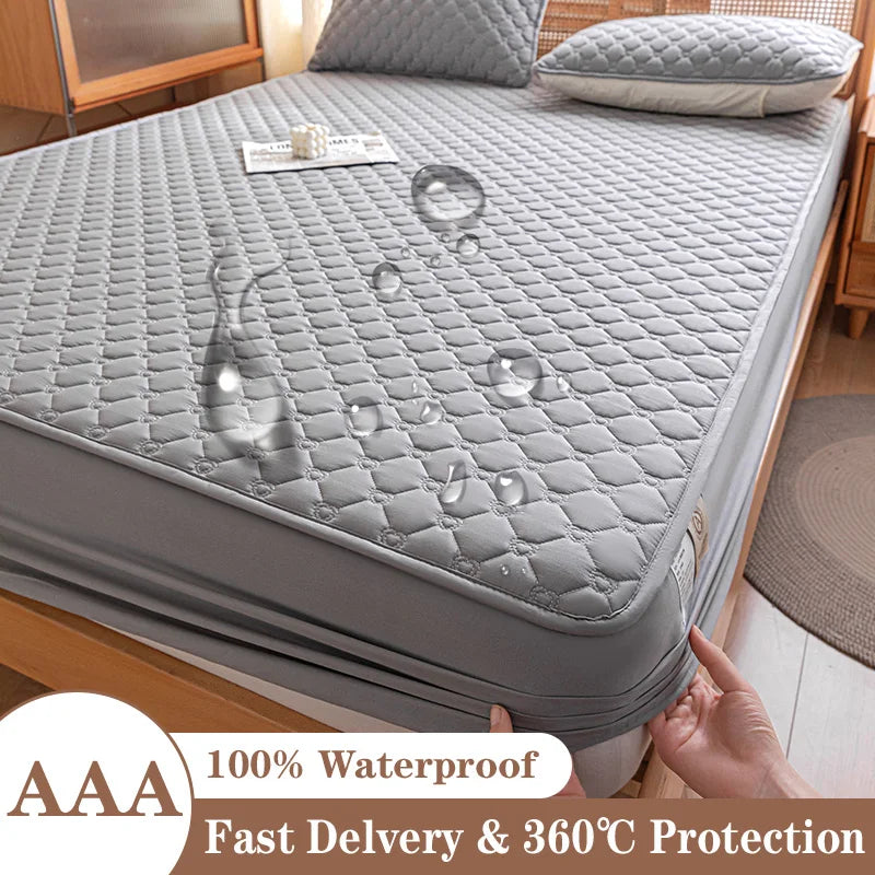 Gray mattress protector on a bed with water droplets demonstrating its waterproof feature, in a bedroom setting.