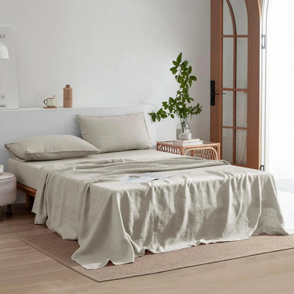 Neatly made bed with beige bedding in a bright bedroom