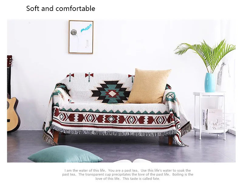 Sofa with a patterned cover in a room with a guitar, plant, and framed picture.