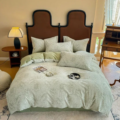 Bedroom with a large bed featuring green bedding and a brown headboard.