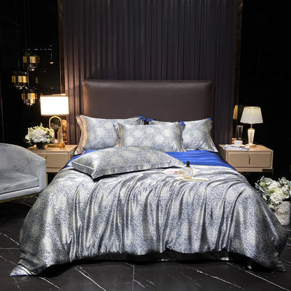 Bedroom with silver and blue bedding set on a bed, nightstands with lamps, and decorative elements.