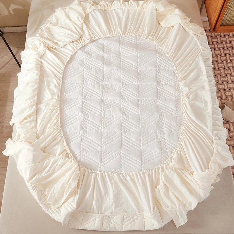Round white cushion with ruffled edge on a light surface