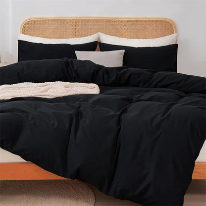 Bed with black bedding and a wicker headboard
