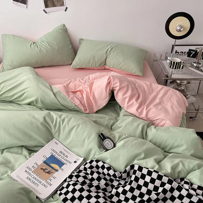 Bed with green and pink bedding, a book, and a bottle on a checkered blanket.