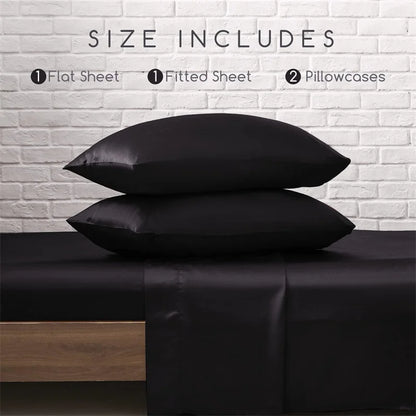 Black satin pillowcases stacked on a bed with a white brick wall background.