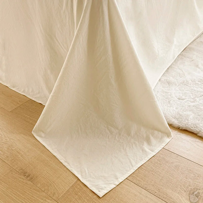 White bed sheets on a wooden floor