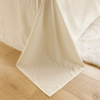 White bed sheets on a wooden floor