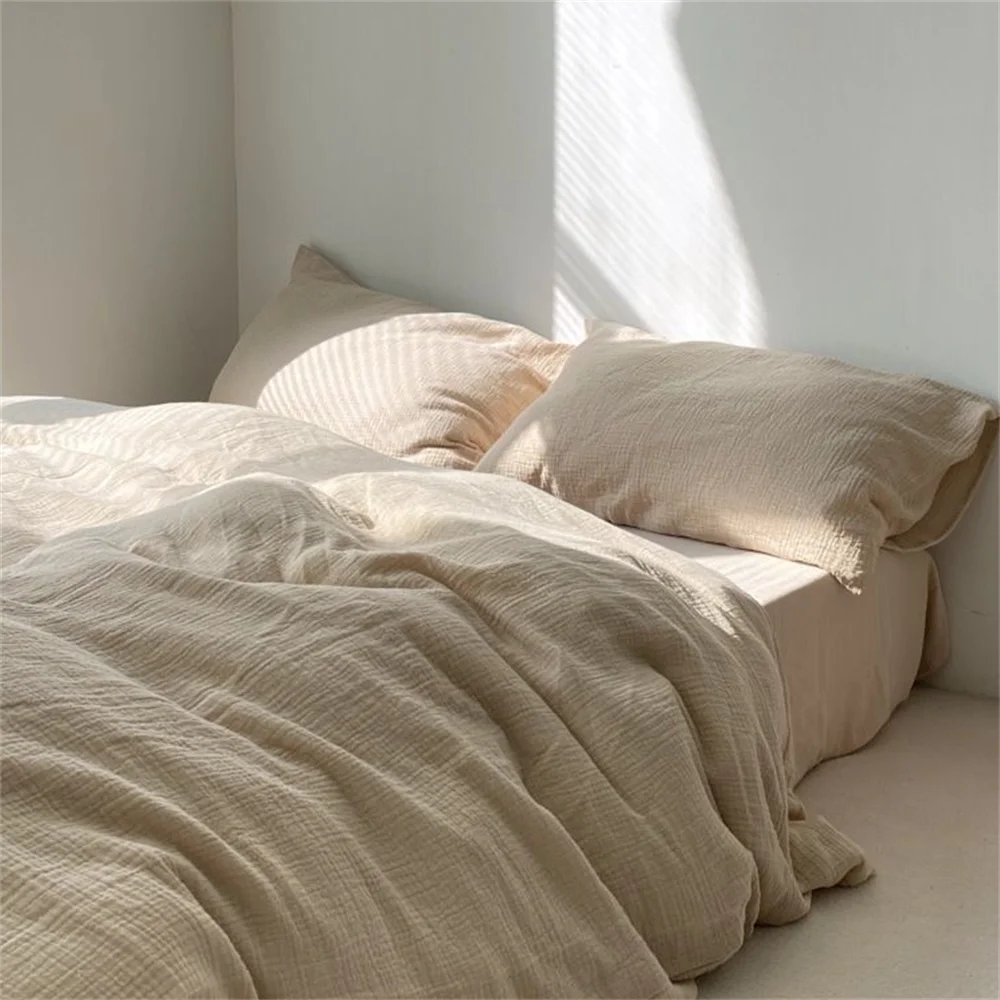 Beige bedding on a bed with soft lighting