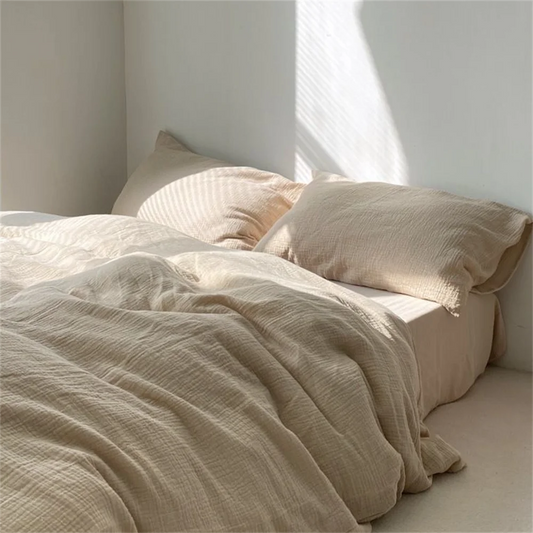 Beige bedding on a bed with soft lighting