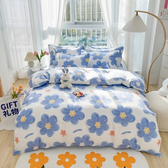 Floral bedding set with blue flowers on a bed in a bright room.