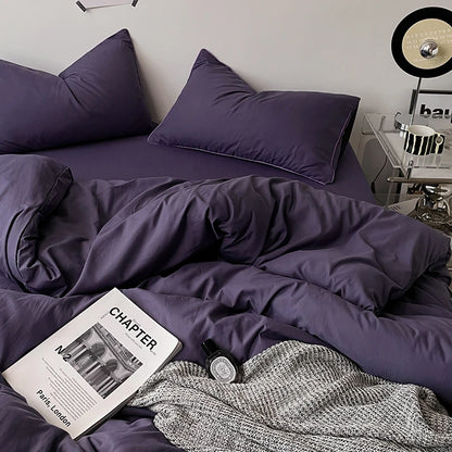 Purple bedding set on a bed with an open book titled 'Chapter' in the foreground.