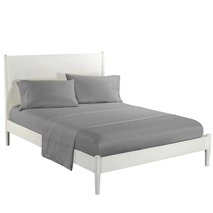Gray bedding set on a white bed frame with a white headboard.