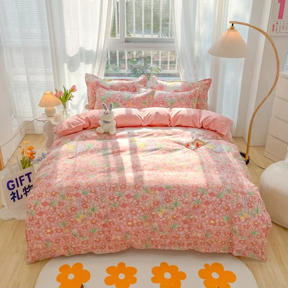 Floral pink bedding set on a bed in a bright room with light-colored walls and decor.