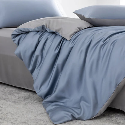 Gray bedding set on a bed with a neutral background