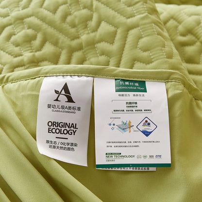 Green quilt with labels on a green background