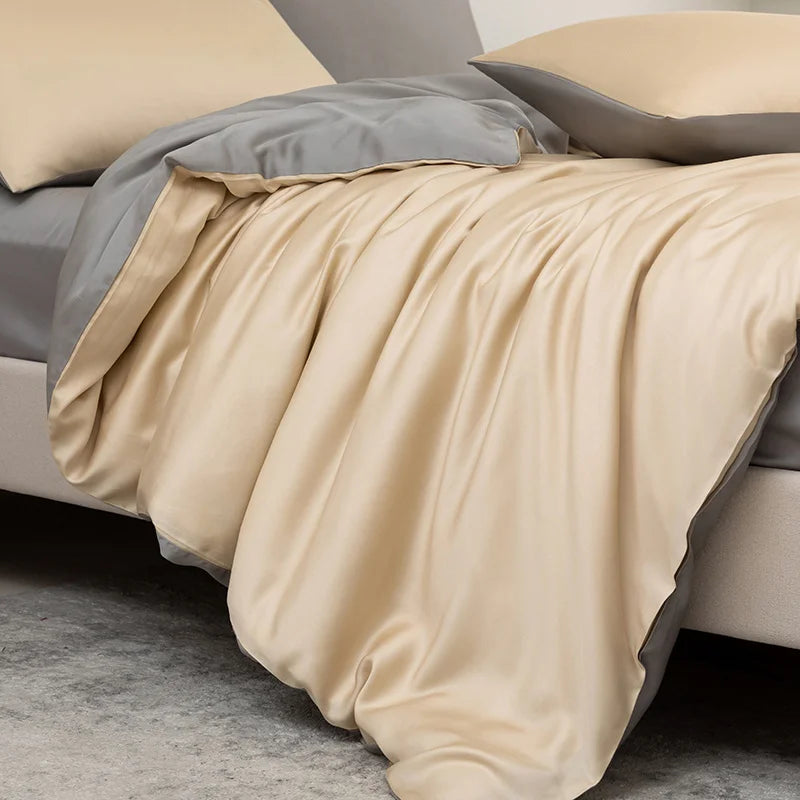 Beige comforter on a bed with gray bedding