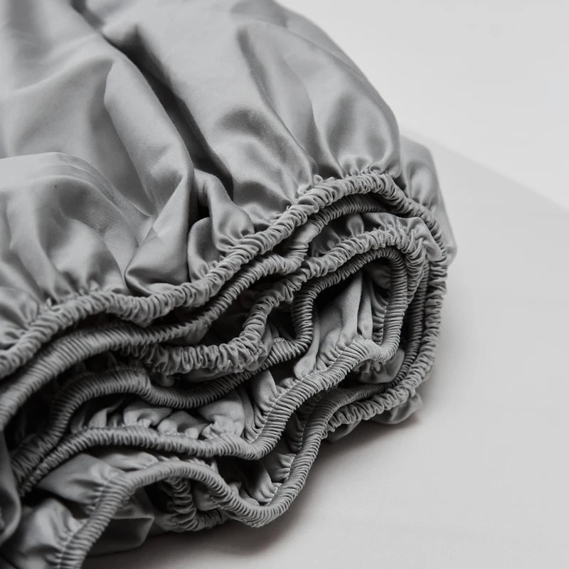 Folded gray satin sheet on a white background