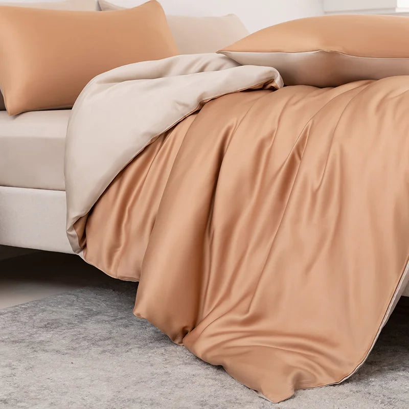 Beige blanket draped over a sofa with beige cushions on a light gray floor.