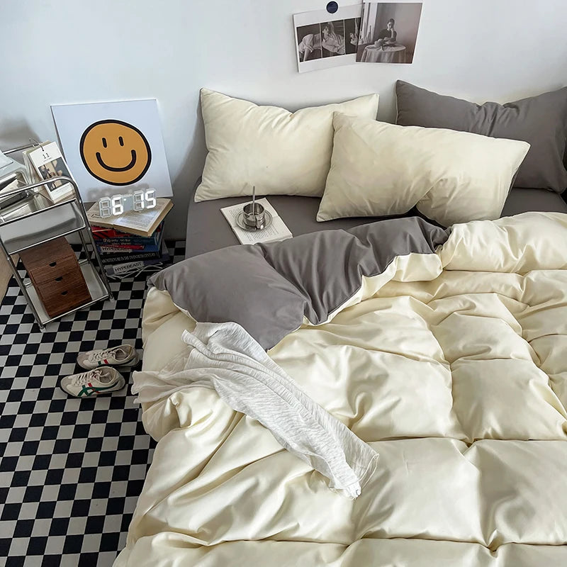Neatly made bed with beige bedding in a room with a checkered floor.