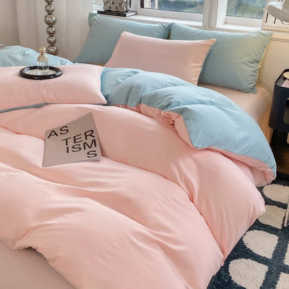 Bed with pink and light blue bedding in a bedroom setting.