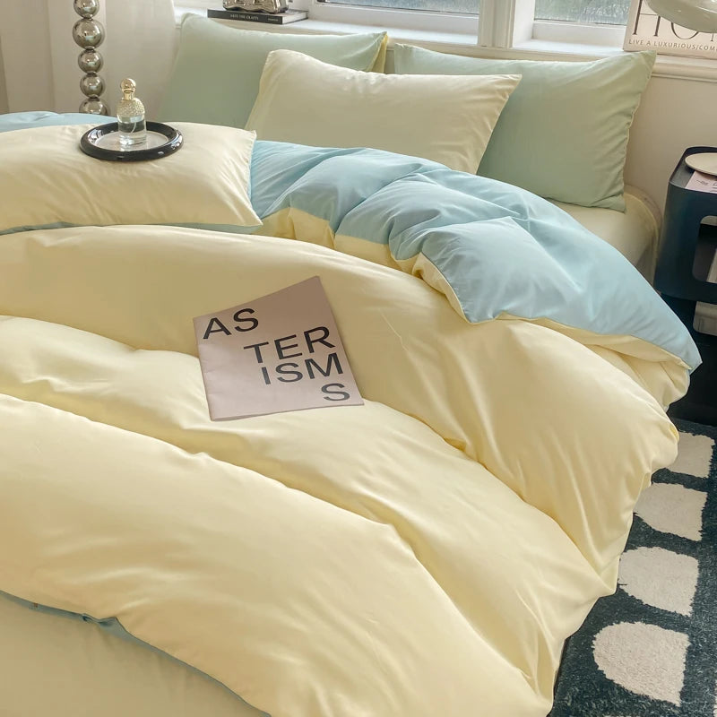 Bed with light-colored bedding and a book titled 'Asterisms' on a bedspread.