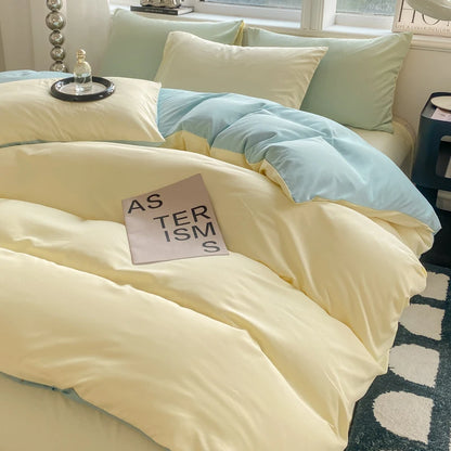 Bed with light-colored bedding and a book titled 'Asterisms' on a bedspread.