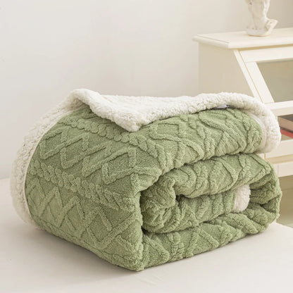 Green textured blanket with white trim on a light surface