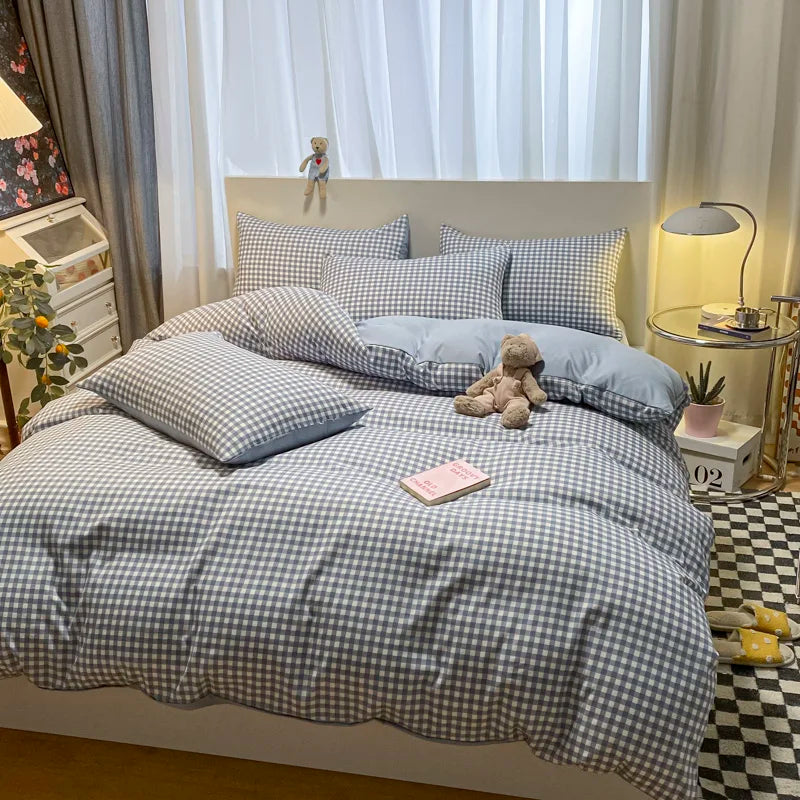 Bedroom with checkered bedding, teddy bear, and small plant.