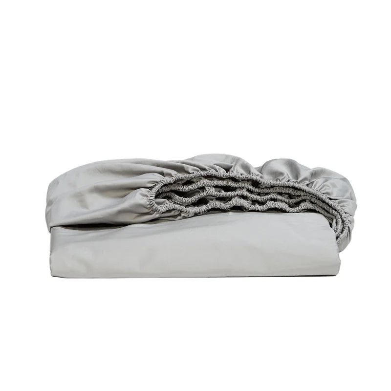 Folded light gray fitted sheet on a white background