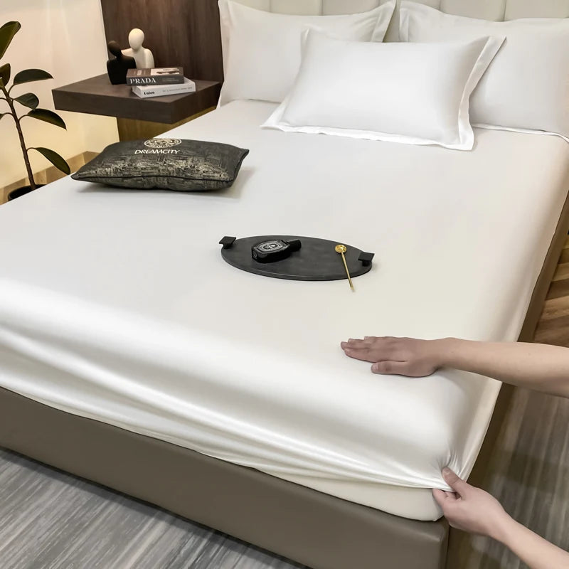 Person adjusting a fitted sheet on a bed in a bedroom setting.