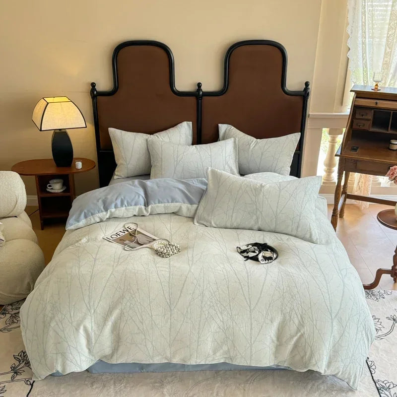 Neatly made bed with white bedding and pillows in a bedroom setting.
