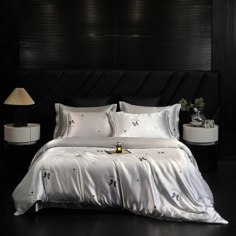 White bedding set with embroidery on a black bed in a darkly decorated room.