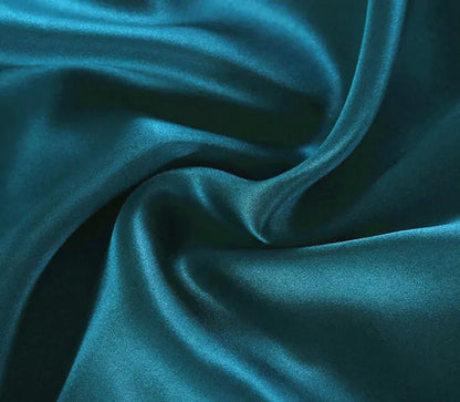 Teal fabric with folds and creases