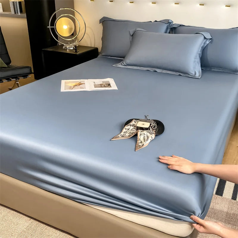 Person adjusting light blue satin sheets on a bed in a bedroom setting.