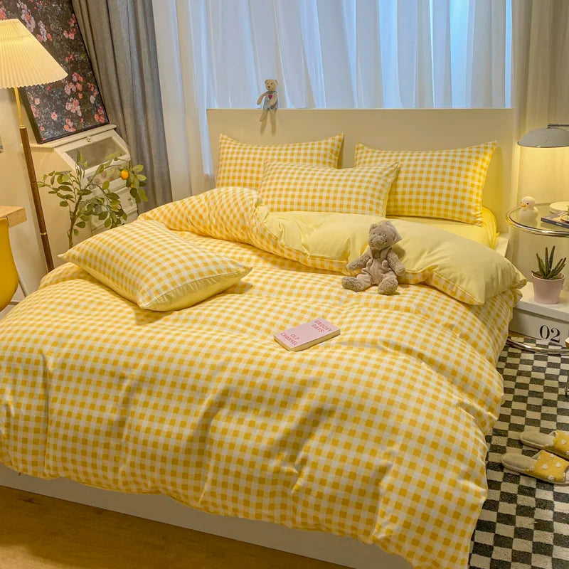 Yellow checkered bedspread on a bed in a bedroom setting with decor elements.