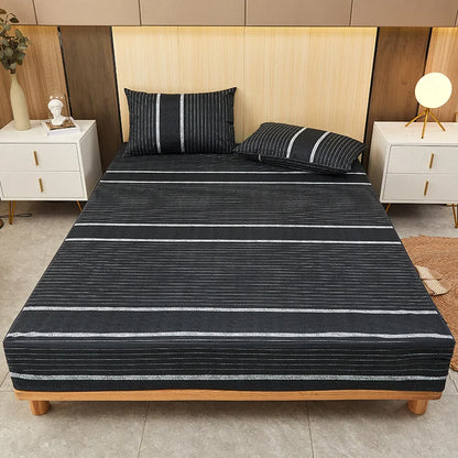 Bed with black and white striped bedding in a bedroom setting