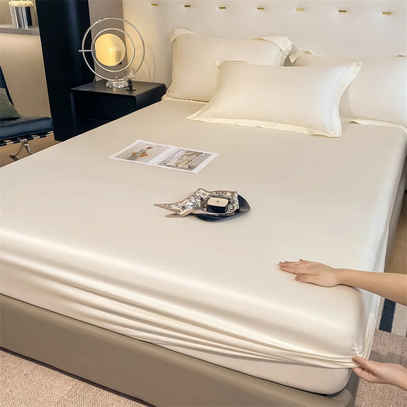 Person adjusting a fitted sheet on a bed in a bedroom setting.