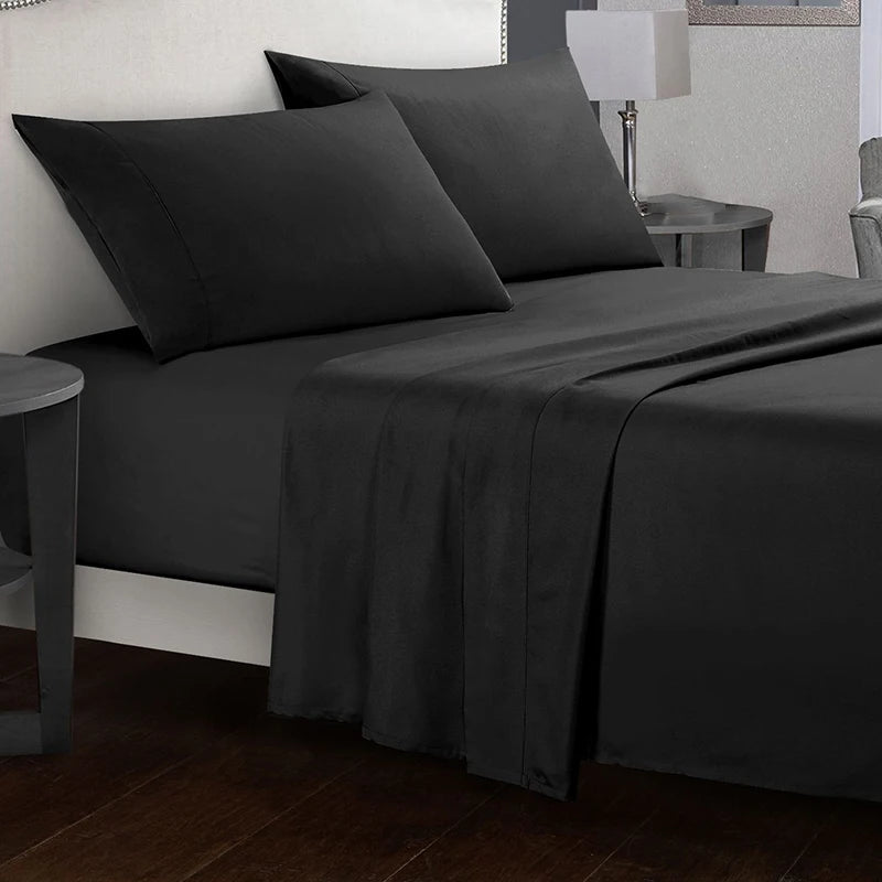 Dark gray bedding set on a bed in a bedroom setting.