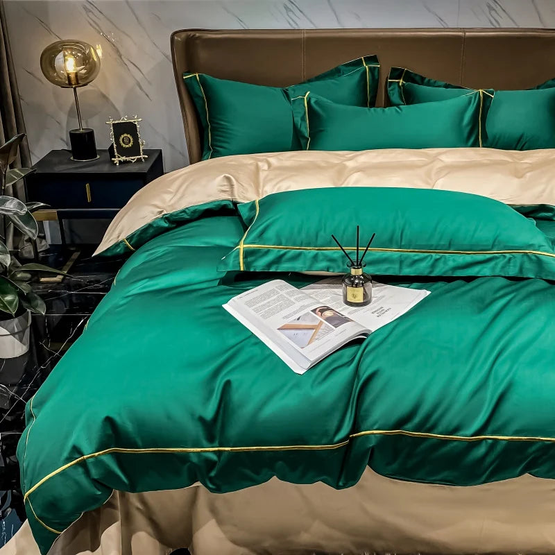 Green and beige bedding set on a bed with decorative items.