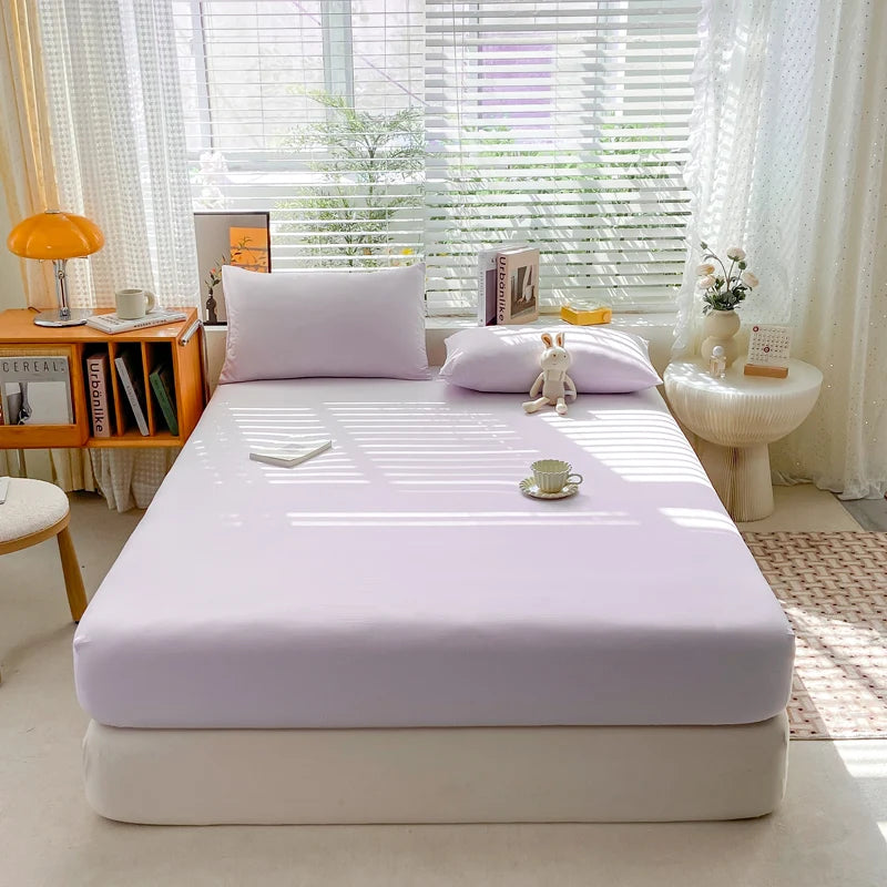 Bed with a white mattress cover in a bright bedroom setting