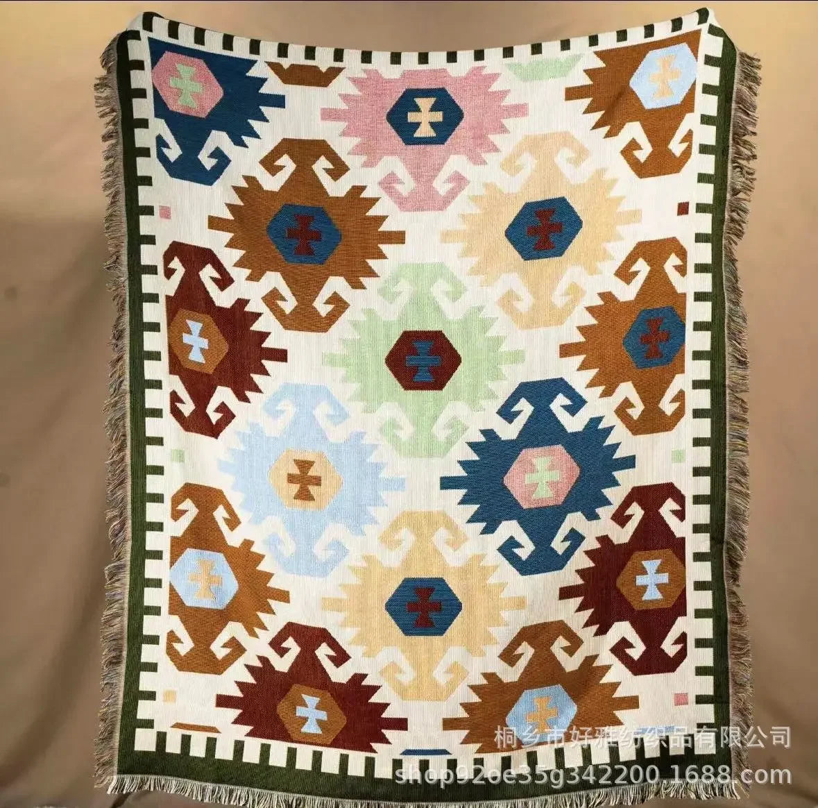 Colorful patterned blanket with geometric design on a beige background