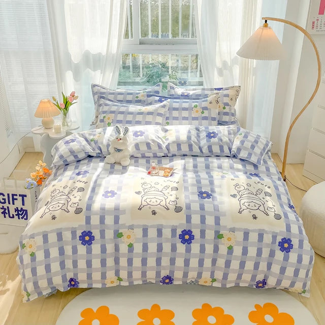 Blue and white checkered bedspread with cartoon designs on a bed in a bright room.