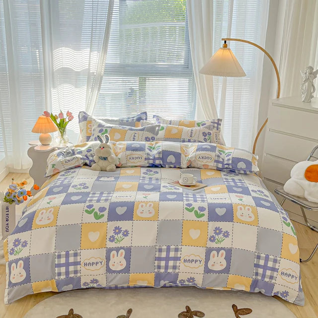 Bed with checkered quilt and patterned pillows in a bright bedroom.